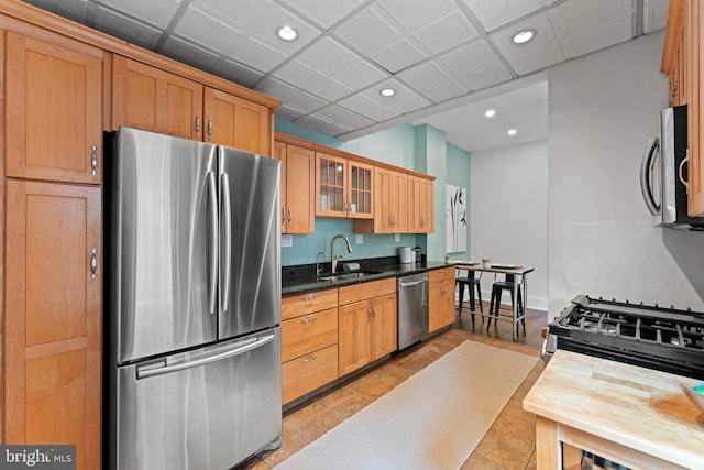 1205 G St NE, Washington, DC 20002 - kitchen with stainless steel appliances, a sink, recessed lighting, glass insert cabinets, and dark stone counters