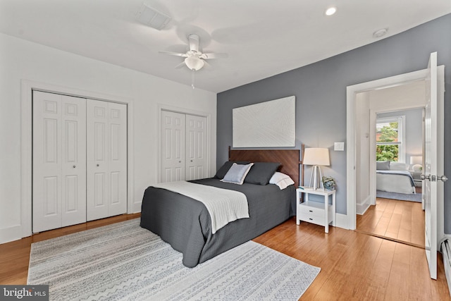 1205 G St NE, Washington, DC 20002 - bedroom with multiple closets, light wood-style flooring, a ceiling fan, and baseboards
