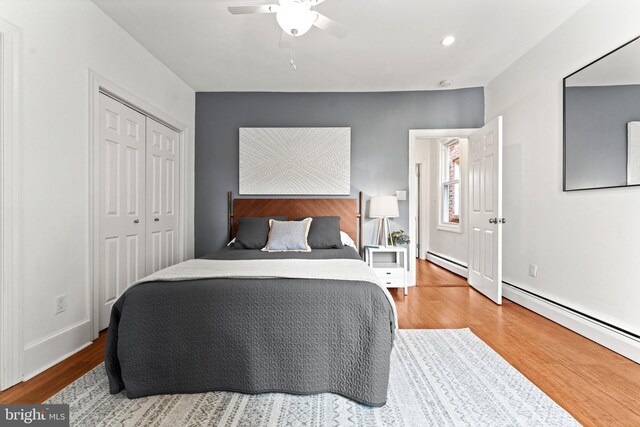 1205 G St NE, Washington, DC 20002 - bedroom with a baseboard radiator, wood finished floors, ceiling fan, a closet, and recessed lighting