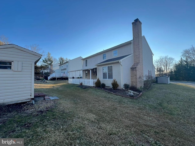 8 Steve Way, Baltimore, MD 21236 - back of house with a chimney, a lawn, and an outbuilding