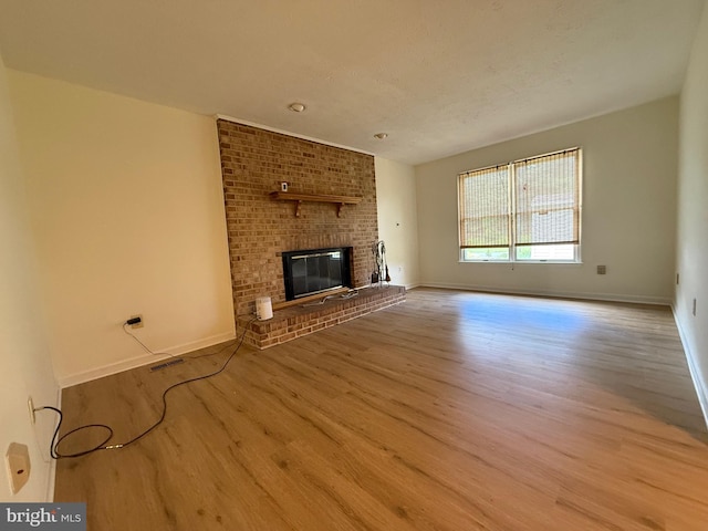 8 Steve Way, Baltimore, MD 21236 - unfurnished living room featuring wood finished floors, baseboards, and a brick fireplace
