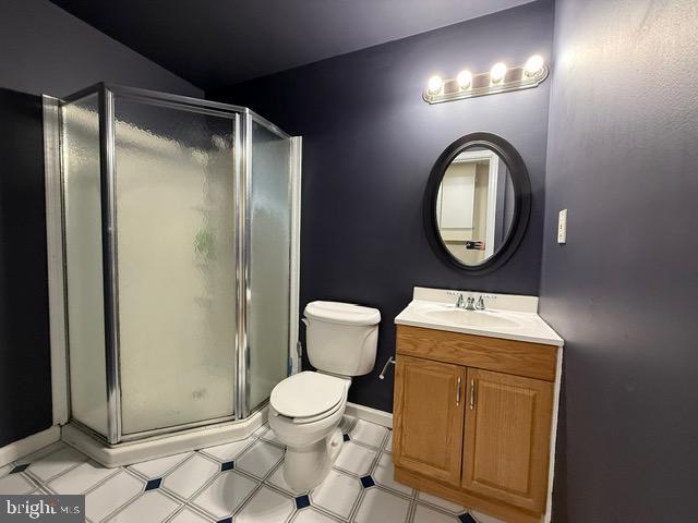 8 Steve Way, Baltimore, MD 21236 - full bath featuring vanity, a shower stall, toilet, baseboards, and tile patterned floors