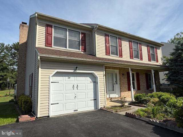 8 Steve Way, Baltimore, MD 21236 - view of front of house with a chimney, an attached garage, covered porch, and driveway