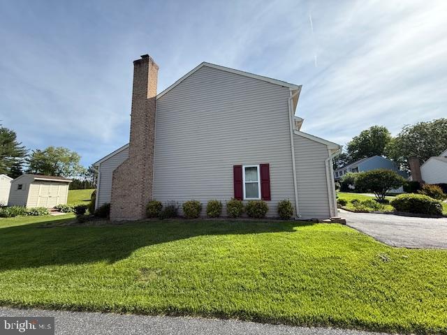 8 Steve Way, Baltimore, MD 21236 - view of side of home featuring a chimney and a yard