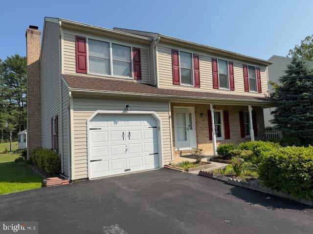 8 Steve Way, Baltimore, MD 21236 - view of front facade featuring a chimney, a garage, asphalt driveway, and covered porch