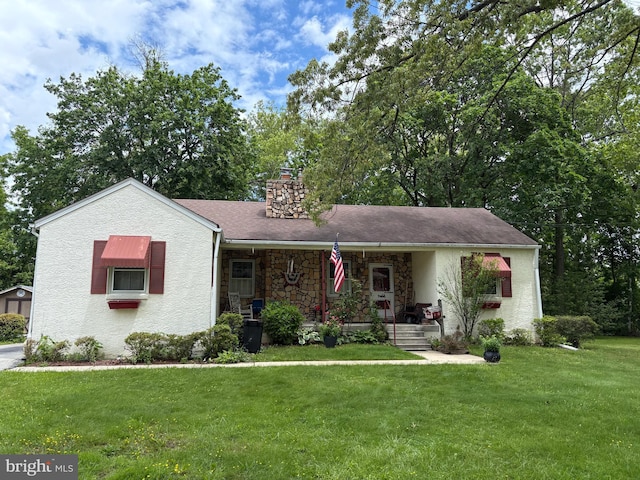 812 Agnes Ave, Morton, PA 19070 - view of front of home featuring a front yard, a chimney, covered porch, stucco siding, and stone siding