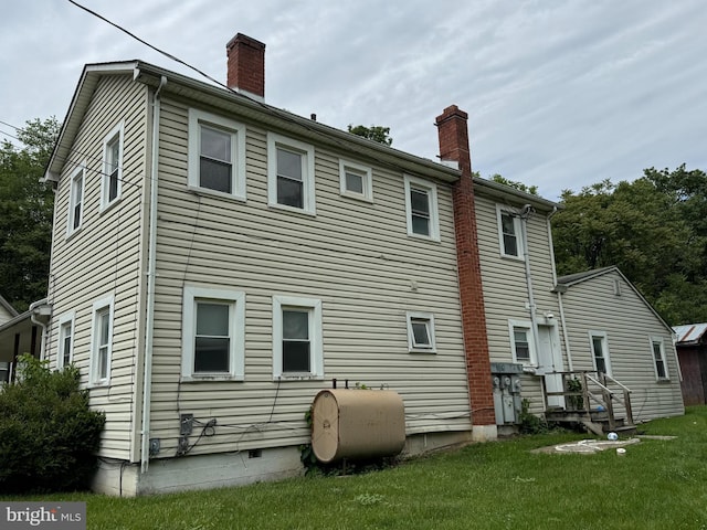 386 Round Hill Rd, Winchester, VA 22602 - rear view of property featuring oil tank, a chimney, and a yard