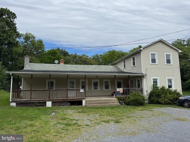 386 Round Hill Rd, Winchester, VA 22602 - view of front of property featuring covered porch, a chimney, and a front lawn