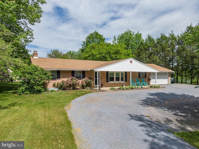 1980 State Route 72 N, Lebanon, PA 17046 - ranch-style house featuring gravel driveway, a front yard, a chimney, an attached garage, and covered porch