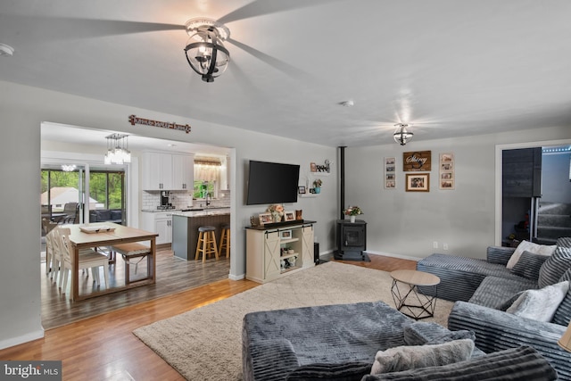 1980 State Route 72 N, Lebanon, PA 17046 - living area featuring a wood stove, a ceiling fan, light wood-style floors, and baseboards