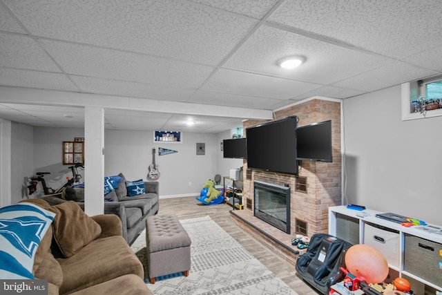 1980 State Route 72 N, Lebanon, PA 17046 - living area with a drop ceiling, light wood-type flooring, baseboards, and a brick fireplace