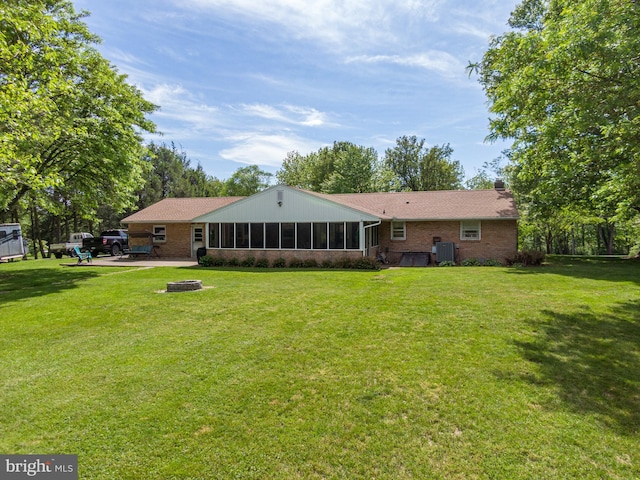 1980 State Route 72 N, Lebanon, PA 17046 - back of property featuring an outdoor fire pit, a sunroom, a patio area, and a lawn