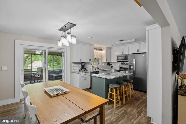1980 State Route 72 N, Lebanon, PA 17046 - kitchen featuring appliances with stainless steel finishes, a sink, a kitchen island, dark wood finished floors, and tasteful backsplash
