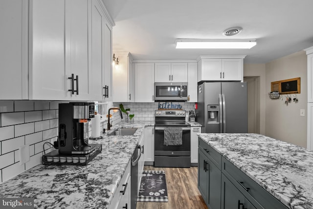 1980 State Route 72 N, Lebanon, PA 17046 - kitchen with appliances with stainless steel finishes, a sink, white cabinetry, and light stone countertops
