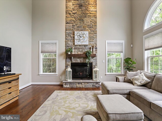 40 Inaugural Way, Charles Town, WV 25414 - living room with a high ceiling, dark wood finished floors, a fireplace, and baseboards