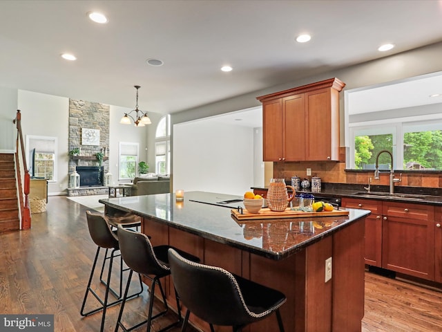 40 Inaugural Way, Charles Town, WV 25414 - kitchen with a sink, a stone fireplace, dark wood-style floors, open floor plan, and dark stone countertops