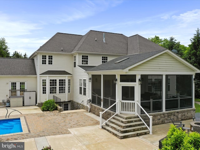 40 Inaugural Way, Charles Town, WV 25414 - back of property featuring a sunroom, a patio area, and a shingled roof