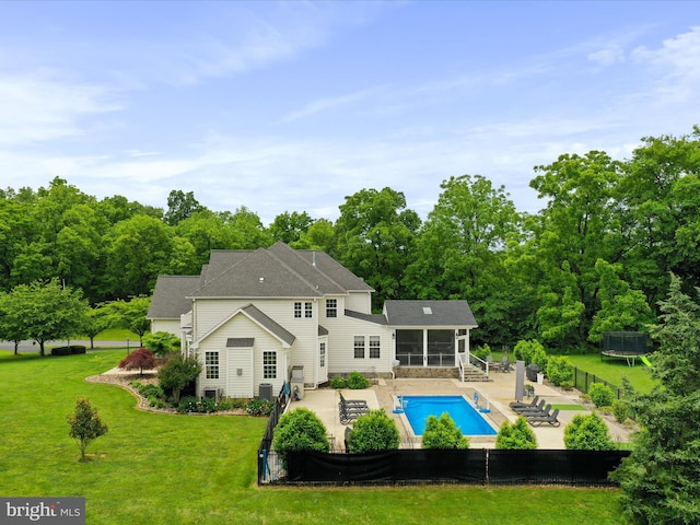 40 Inaugural Way, Charles Town, WV 25414 - rear view of house with a trampoline, a patio, and a sunroom