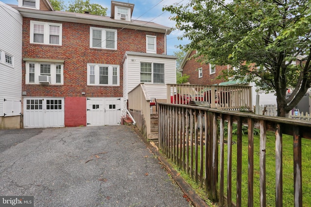 530 Gregg St, Shillington, PA 19607 - rear view of house with a garage, brick siding, asphalt driveway, and cooling unit