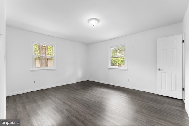 304 Montfield Ln, Glen Burnie, MD 21061 - empty room with plenty of natural light, dark wood-style floors, and baseboards
