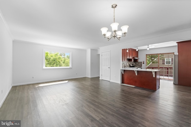 304 Montfield Ln, Glen Burnie, MD 21061 - kitchen featuring a chandelier, ornamental molding, healthy amount of natural light, light countertops, and a kitchen bar