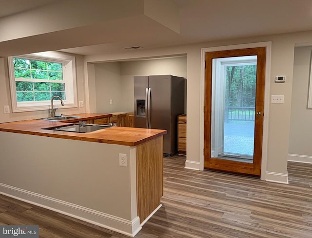 18 Bolton Branch Ln, Huntly, VA 22640 - kitchen featuring wooden counters, stainless steel refrigerator with ice dispenser, black electric cooktop, dark wood finished floors, and a peninsula