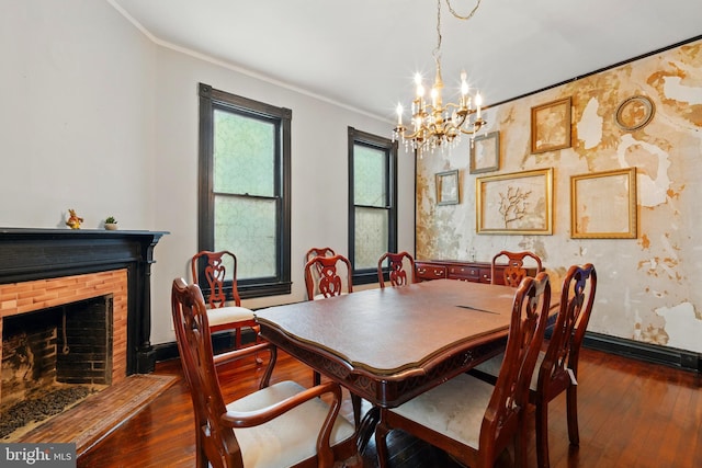 706 Locust St, Cambridge, MD 21613 - dining space with a chandelier, ornamental molding, dark wood-type flooring, baseboards, and a fireplace