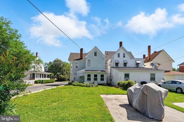 706 Locust St, Cambridge, MD 21613 - rear view of house featuring a lawn