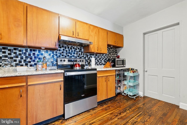 706 Locust St, Cambridge, MD 21613 - kitchen with stainless steel appliances, under cabinet range hood, dark wood-type flooring, backsplash, and light stone counters