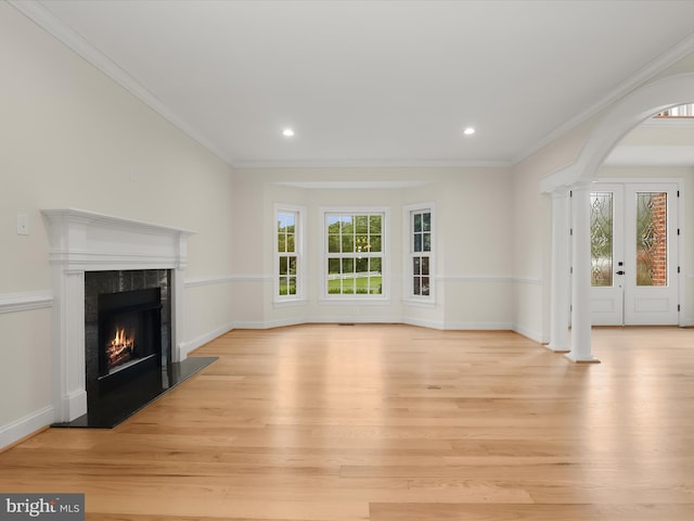 6419 Homebuilder Dr, Mount Airy, MD 21771 - unfurnished living room with light wood-type flooring, a premium fireplace, arched walkways, crown molding, and recessed lighting