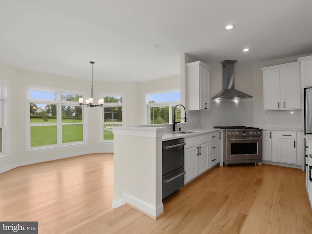 6419 Homebuilder Dr, Mount Airy, MD 21771 - kitchen with wall chimney exhaust hood, appliances with stainless steel finishes, a sink, a chandelier, and light wood finished floors