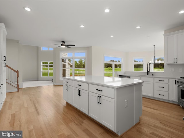 6419 Homebuilder Dr, Mount Airy, MD 21771 - kitchen featuring ceiling fan, a kitchen island, healthy amount of natural light, light wood-style floors, and recessed lighting