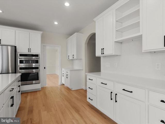 6419 Homebuilder Dr, Mount Airy, MD 21771 - kitchen with stainless steel appliances, arched walkways, light countertops, white cabinets, and recessed lighting