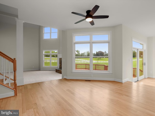6419 Homebuilder Dr, Mount Airy, MD 21771 - unfurnished living room with light wood-style floors, stairway, a fireplace, ceiling fan, and baseboards