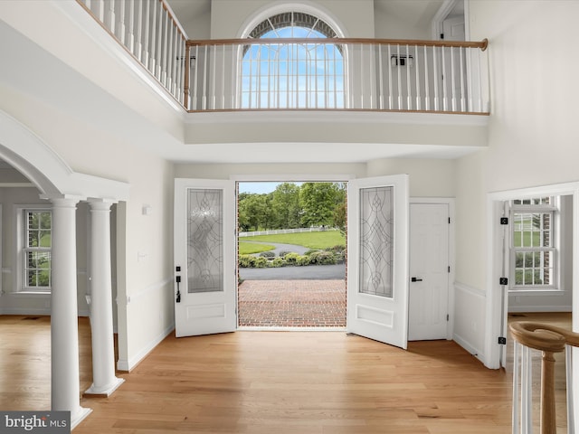 6419 Homebuilder Dr, Mount Airy, MD 21771 - foyer entrance with a high ceiling, wood finished floors, arched walkways, and decorative columns