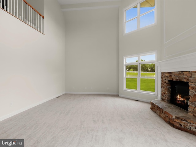 6419 Homebuilder Dr, Mount Airy, MD 21771 - unfurnished living room with a high ceiling, carpet, a stone fireplace, and baseboards