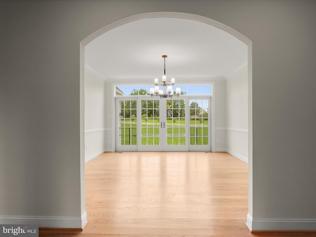 6419 Homebuilder Dr, Mount Airy, MD 21771 - unfurnished dining area featuring arched walkways, ornamental molding, light wood-style floors, and baseboards
