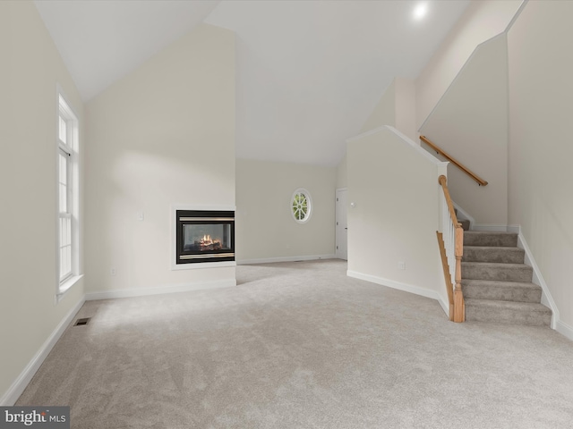 6419 Homebuilder Dr, Mount Airy, MD 21771 - unfurnished living room with carpet flooring, stairway, high vaulted ceiling, a multi sided fireplace, and baseboards