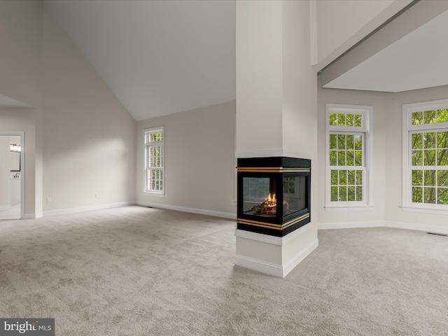 6419 Homebuilder Dr, Mount Airy, MD 21771 - unfurnished living room with carpet floors, high vaulted ceiling, a multi sided fireplace, and baseboards