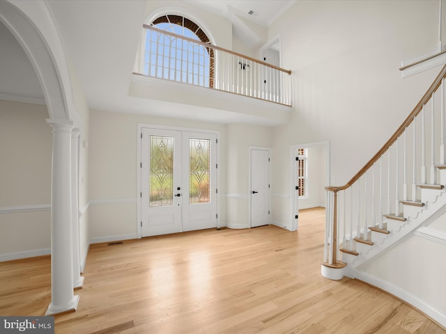 6419 Homebuilder Dr, Mount Airy, MD 21771 - entryway with light wood-style floors, arched walkways, stairway, ornate columns, and a towering ceiling