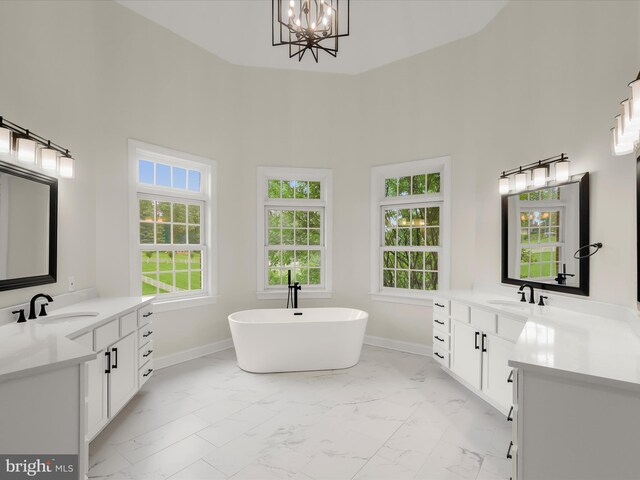 6419 Homebuilder Dr, Mount Airy, MD 21771 - bathroom featuring marble finish flooring, two vanities, plenty of natural light, and a high ceiling