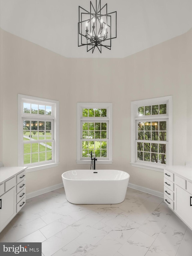 6419 Homebuilder Dr, Mount Airy, MD 21771 - bathroom with vanity, marble look tiles, a freestanding tub, baseboards, and a towering ceiling