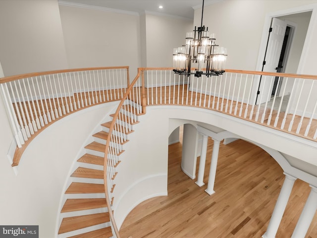 6419 Homebuilder Dr, Mount Airy, MD 21771 - stairway with wood finished floors, a chandelier, crown molding, a high ceiling, and recessed lighting
