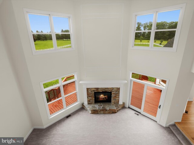 6419 Homebuilder Dr, Mount Airy, MD 21771 - unfurnished living room with carpet flooring, baseboards, and a stone fireplace