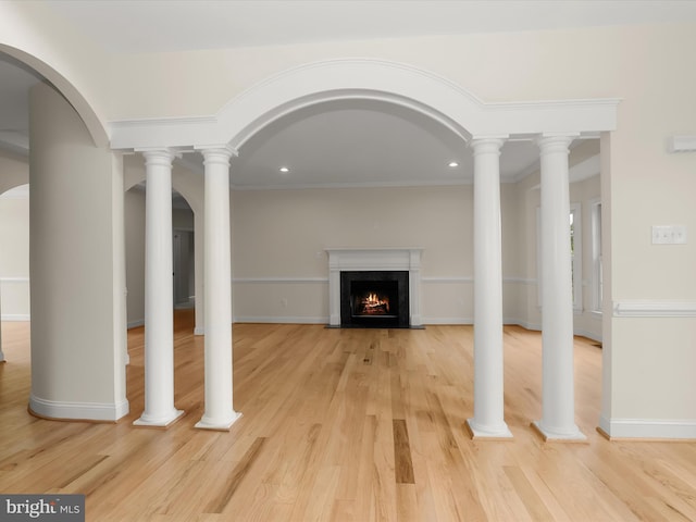 6419 Homebuilder Dr, Mount Airy, MD 21771 - unfurnished living room with a warm lit fireplace, light wood-style flooring, recessed lighting, baseboards, and arched walkways