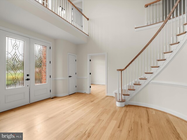 6419 Homebuilder Dr, Mount Airy, MD 21771 - entryway with french doors, wood finished floors, a high ceiling, baseboards, and stairway