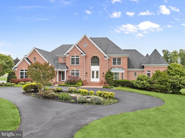 6419 Homebuilder Dr, Mount Airy, MD 21771 - colonial inspired home featuring curved driveway, french doors, a front lawn, and brick siding