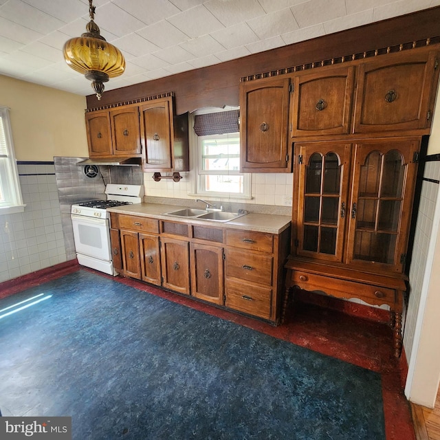 2102 Princeton Pike, Lawrence Township, NJ 08648 - kitchen with gas range gas stove, a sink, brown cabinetry, tile walls, and wainscoting