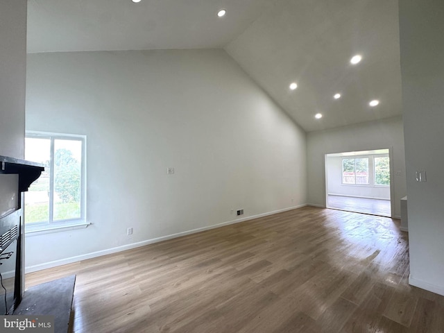 23 Karen Ct, New Castle, DE 19720 - unfurnished living room featuring high vaulted ceiling, recessed lighting, wood finished floors, and baseboards
