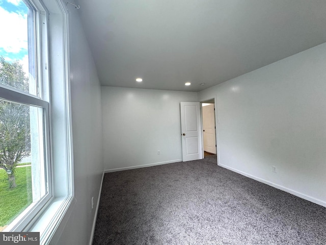 23 Karen Ct, New Castle, DE 19720 - empty room with dark carpet, plenty of natural light, recessed lighting, and baseboards